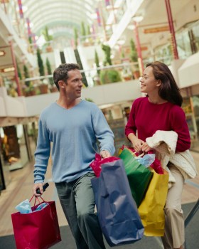 Couple Carrying Shopping Bags in Mall
